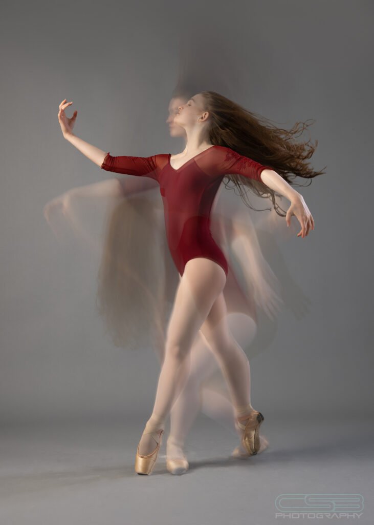long exposure photo of dancer in red tights